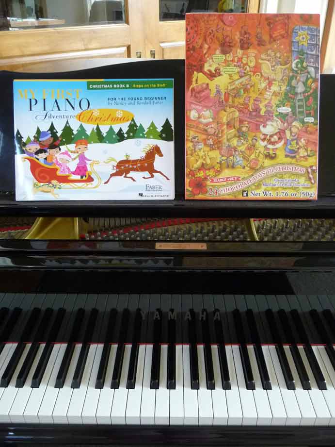 piano with Christmas book and chocolate advent calendar