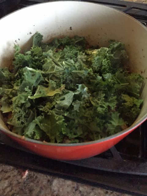adding kale to meat sauce